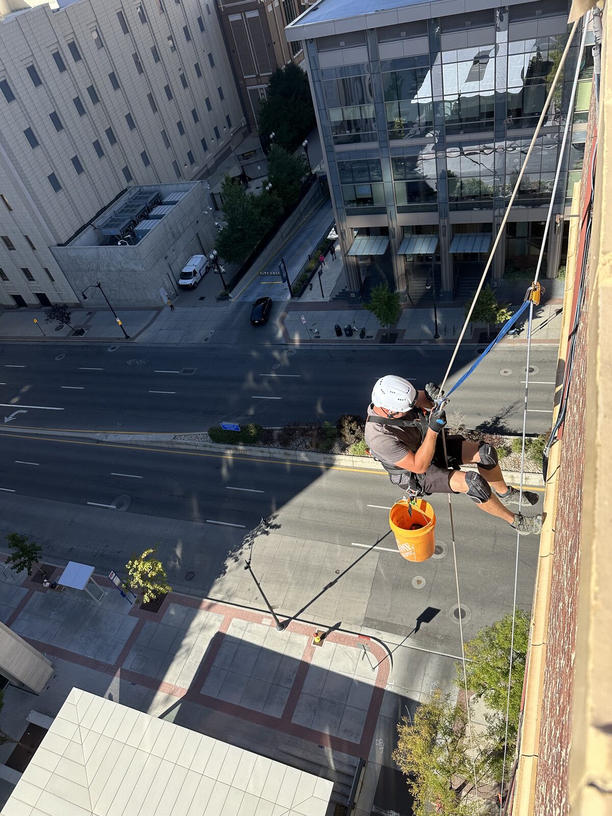 Technician descending a multistory building exterior