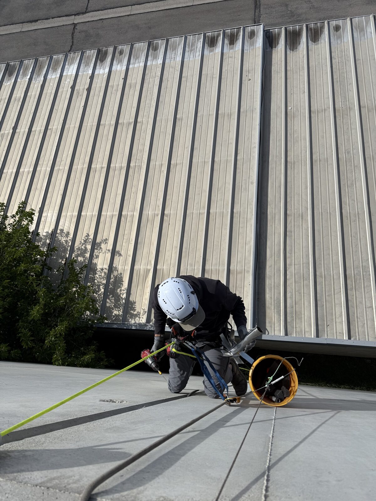 Technician carrying repair materials on a rope system